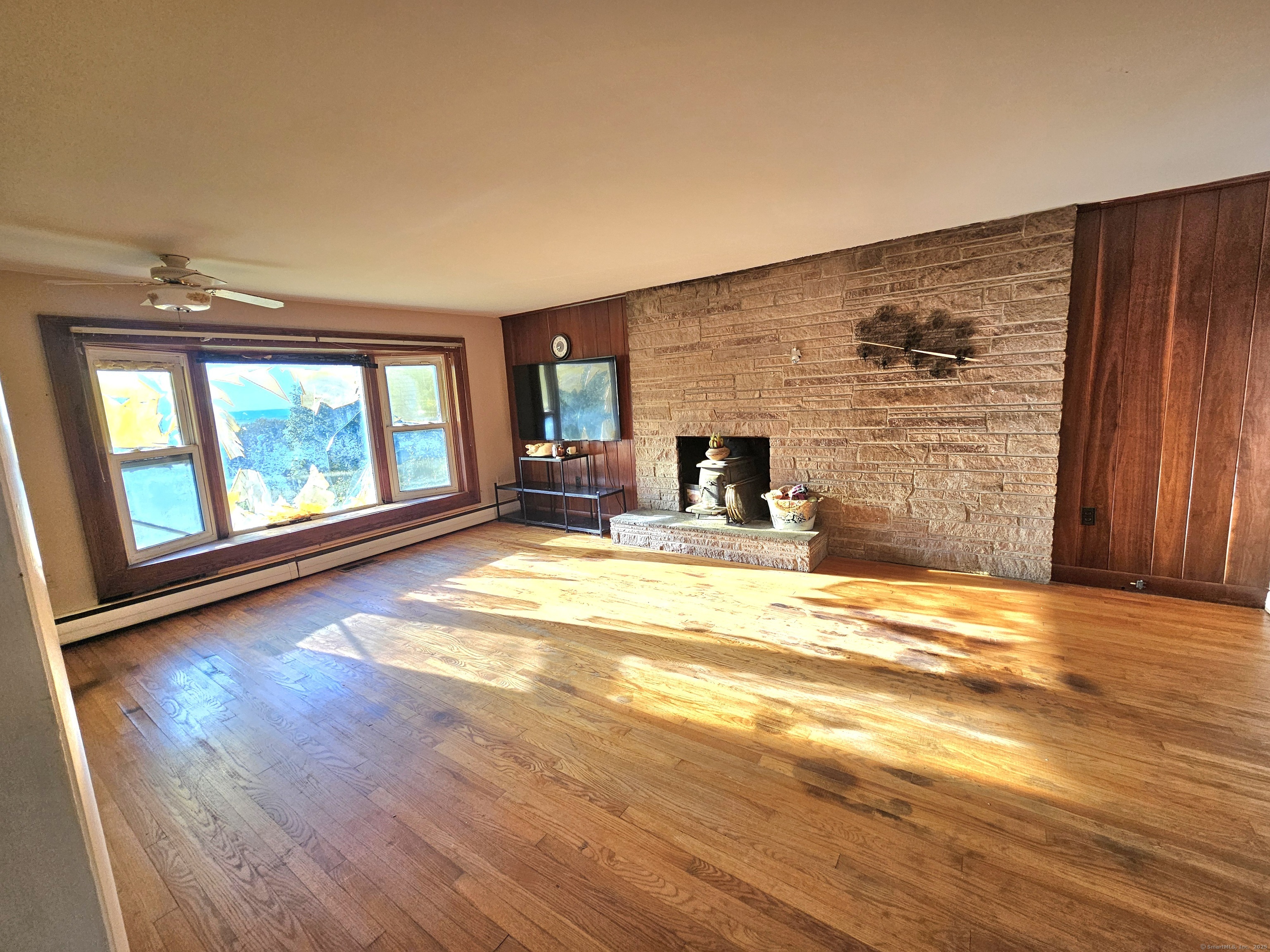 1415 North Road Killingly, CT 06241 - Photo 12 of 20 a view of empty room with wooden floor and fan