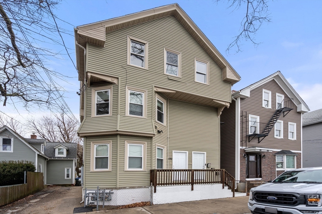 170 Allston Street, Unit 1 Providence, RI 02908 - Photo 11 of 12 a front view of a house with cars parked