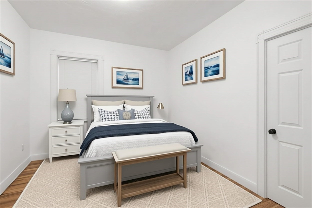 170 Allston Street, Unit 1 Providence, RI 02908 - Photo 7 of 12 a bedroom with a bed and a wall painting