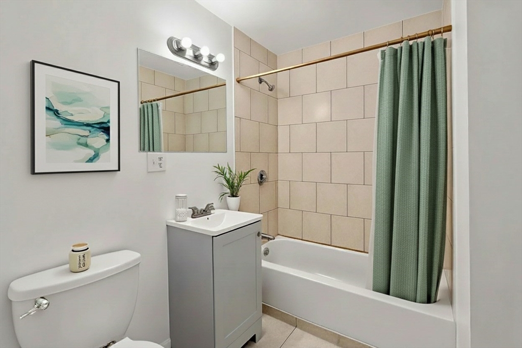 170 Allston Street, Unit 1 Providence, RI 02908 - Photo 8 of 12 a bathroom with a sink a toilet and shower