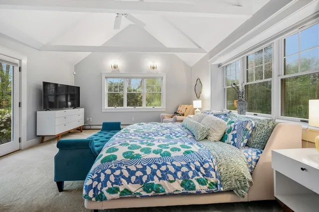 a bedroom with a bed and glass window