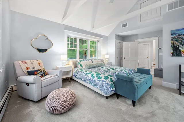 a bedroom with bed and a large window