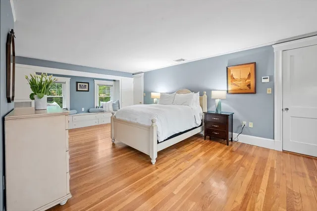 a bedroom with a bed and a potted plant