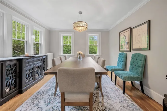 a view of a a dining room with furniture window and wooden floor