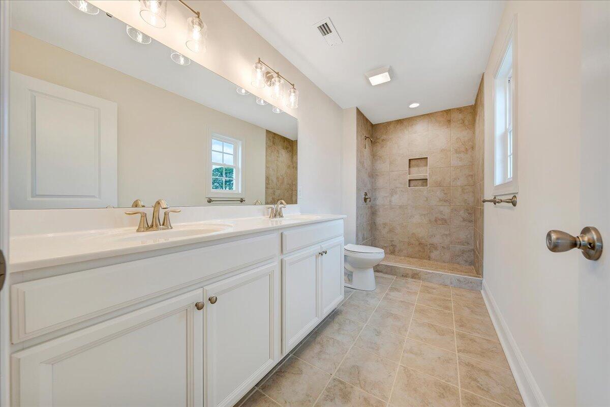 300 Ridgley Lane Fincastle, VA 24090 - Photo 13 of 19 a spacious bathroom with a double vanity sink toilet mirror and shower