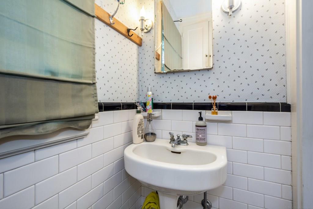 62 Theodore Road Newton, MA 02459 - Photo 12 of 29 a bathroom with a sink a toilet and mirror