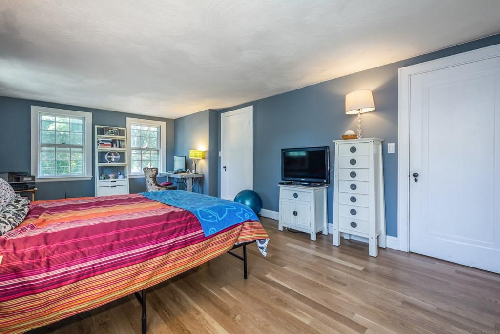 62 Theodore Road Newton, MA 02459 - Photo 13 of 29 a bedroom with a bed and a flat screen tv