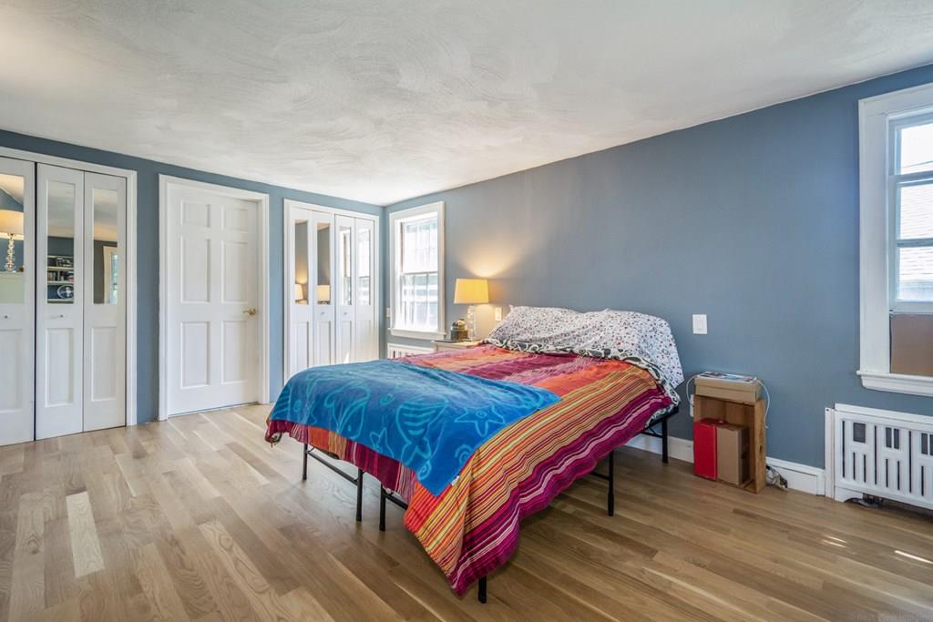 62 Theodore Road Newton, MA 02459 - Photo 14 of 29 a bedroom with a bed a lamp and a closet