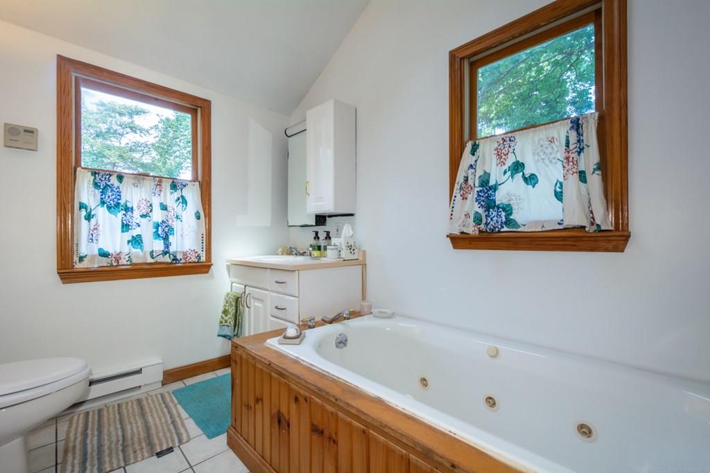62 Theodore Road Newton, MA 02459 - Photo 16 of 29 a bathroom with a tub a sink and a window