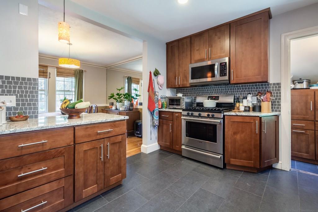 62 Theodore Road Newton, MA 02459 - Photo 10 of 29 a kitchen with stainless steel appliances granite countertop a stove a sink and a microwave