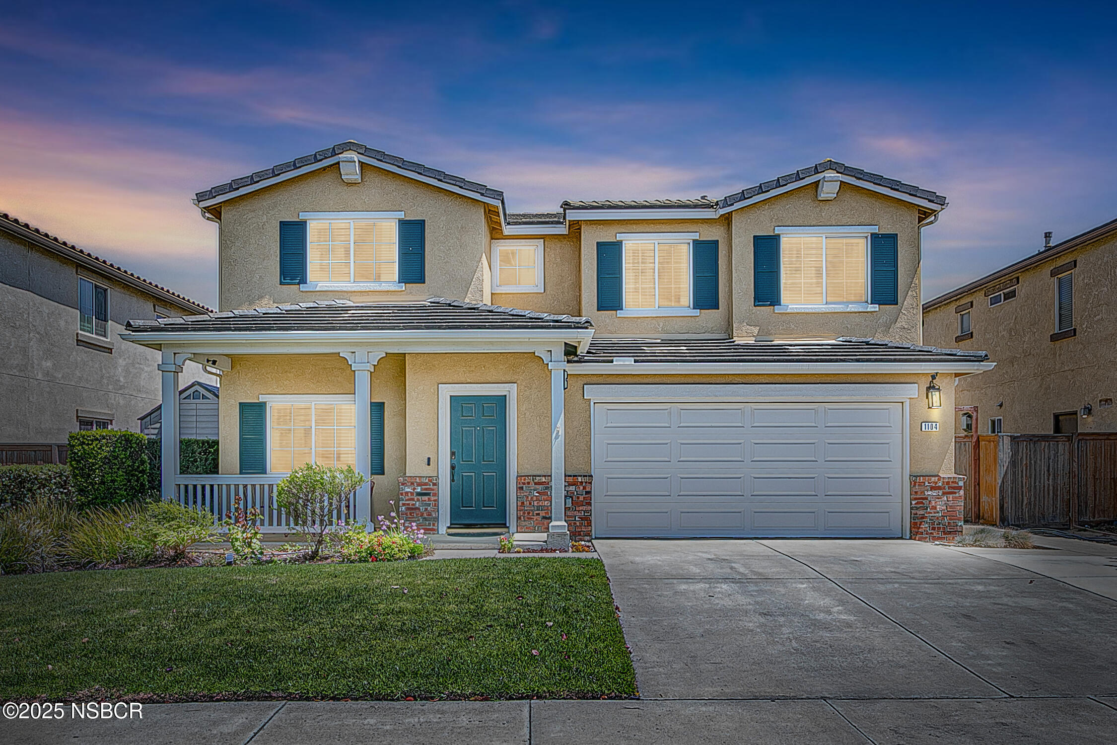 1104 Honda Way Lompoc, CA 93436 - Photo 12 of 36 a front view of a house with a yard and garage