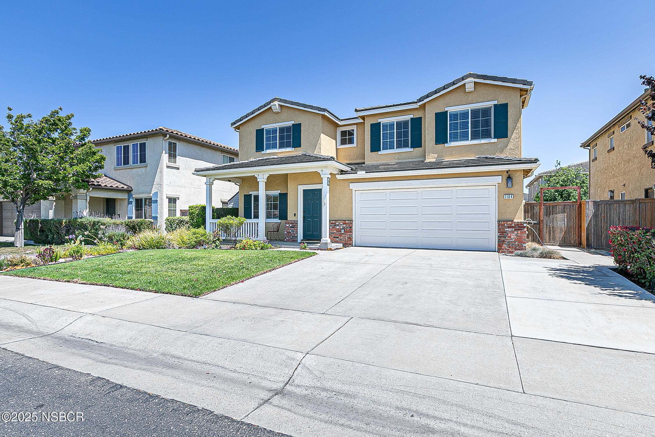 1104 Honda Way Lompoc, CA 93436 - Photo 13 of 36 a front view of a house with a yard and garage