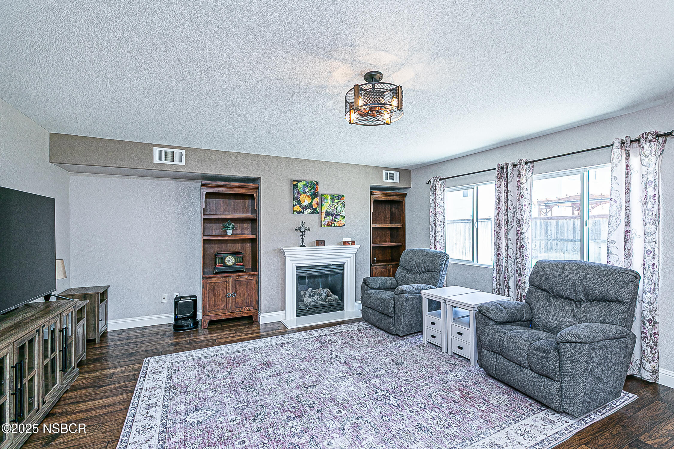 1104 Honda Way Lompoc, CA 93436 - Photo 14 of 36 a living room with furniture a flat screen tv and a fireplace