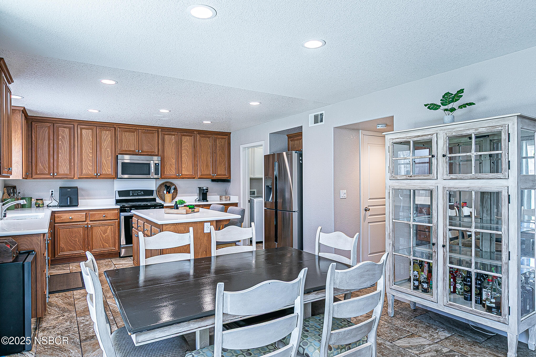 1104 Honda Way Lompoc, CA 93436 - Photo 17 of 36 a kitchen with stainless steel appliances granite countertop a refrigerator a stove a kitchen island a dining table and chairs