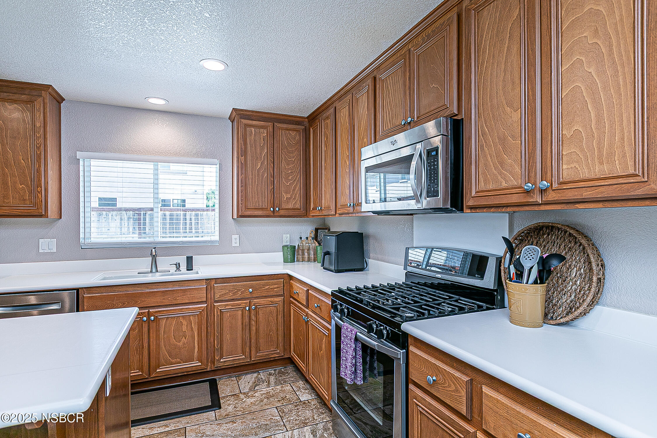 1104 Honda Way Lompoc, CA 93436 - Photo 19 of 36 a kitchen with stainless steel appliances granite countertop a stove a sink and a microwave
