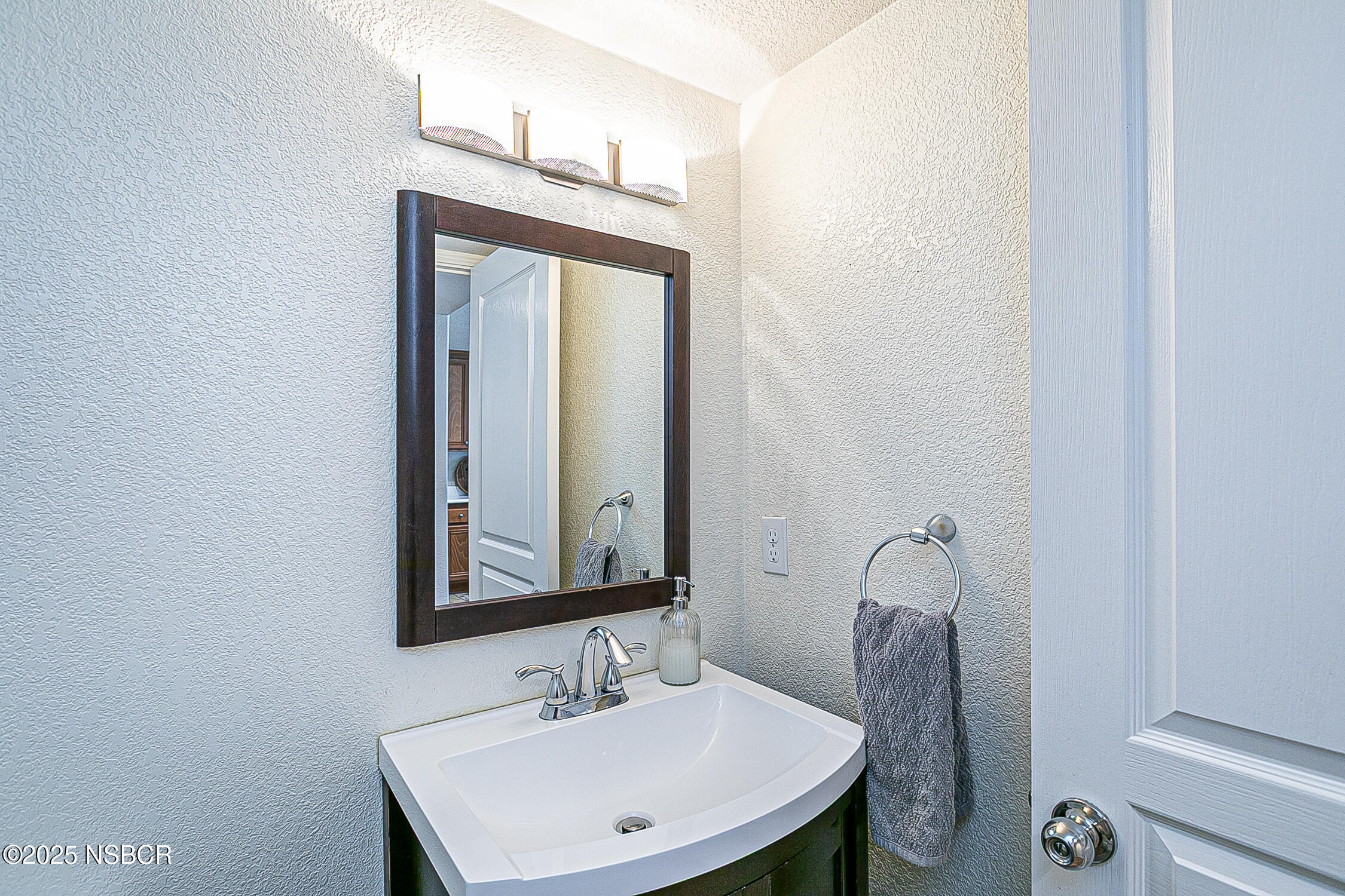 1104 Honda Way Lompoc, CA 93436 - Photo 28 of 36 a bathroom with a sink vanity and a mirror