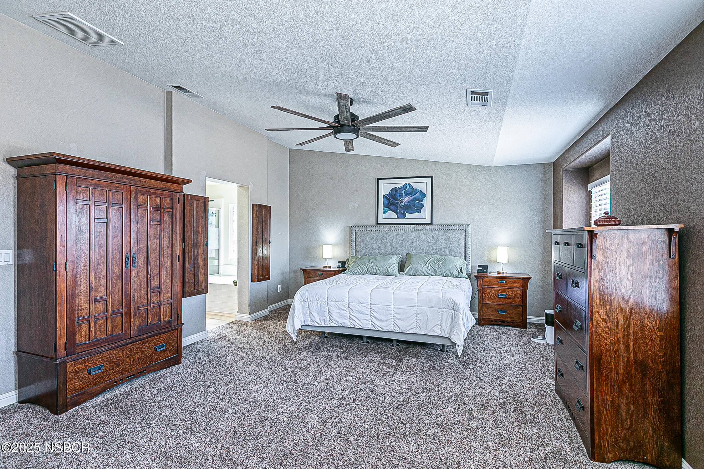 1104 Honda Way Lompoc, CA 93436 - Photo 6 of 36 a spacious bedroom with a bed and a chandelier