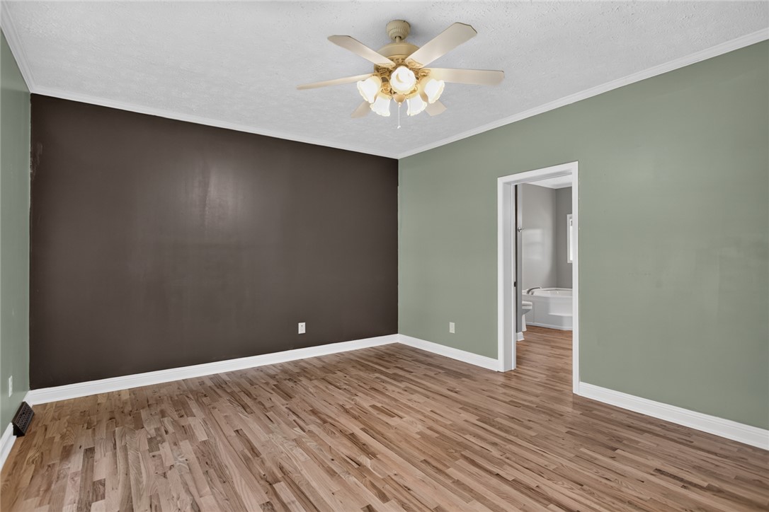 564 Fairfield Road Walhalla, SC 29691 - Photo 19 of 50 Rich hardwood floors and classic crown molding define this spacious room leading to a bath.
