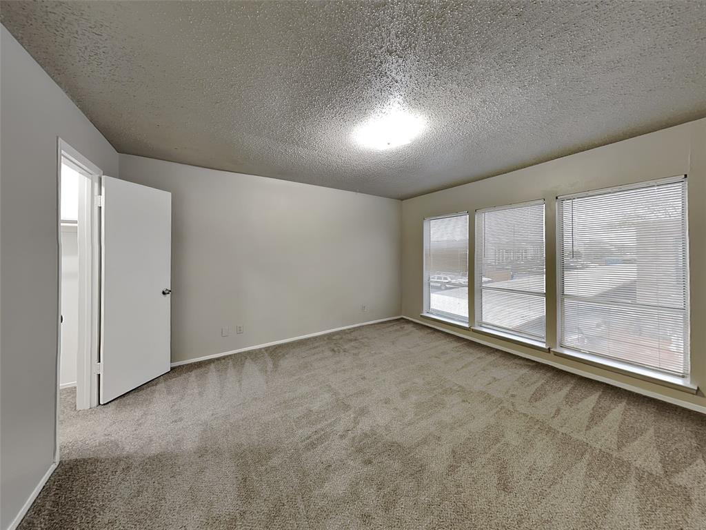 5618 Boca Raton Boulevard, Unit 143 Fort Worth, TX 76112 - Photo 5 of 10 an empty room with large windows