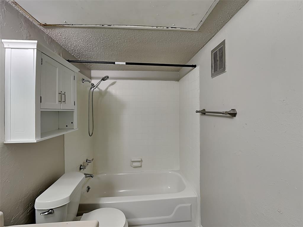 5618 Boca Raton Boulevard, Unit 143 Fort Worth, TX 76112 - Photo 9 of 10 a bathroom with a bathtub and a shower