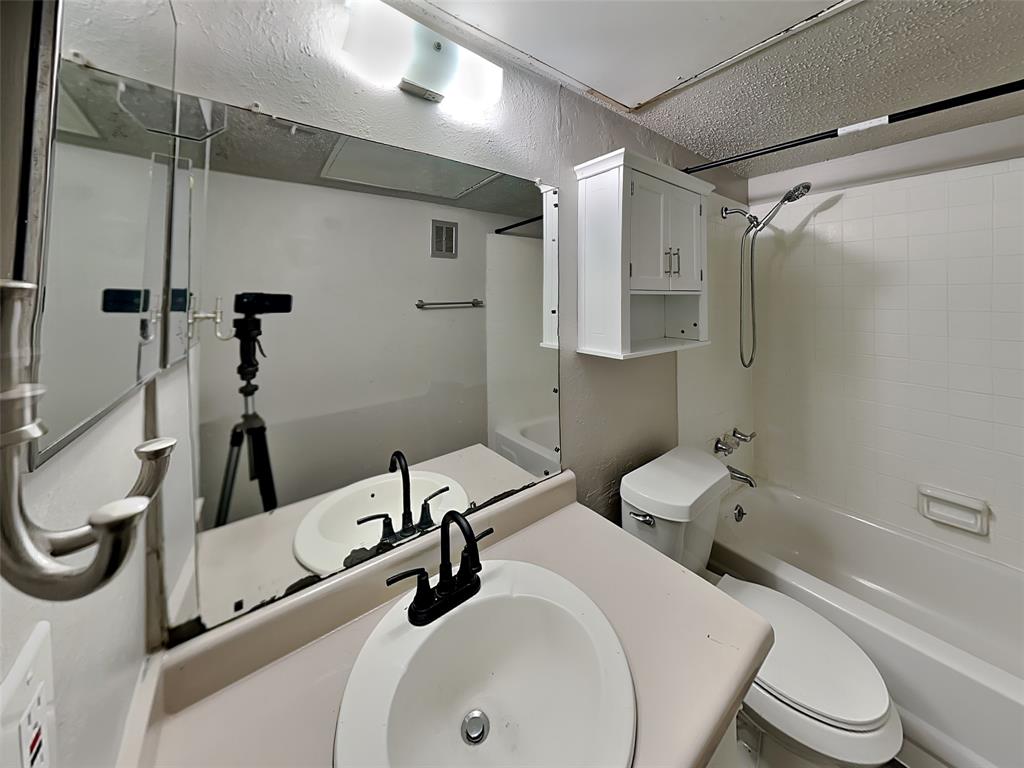 5618 Boca Raton Boulevard, Unit 143 Fort Worth, TX 76112 - Photo 10 of 10 a bathroom with a sink a toilet and shower