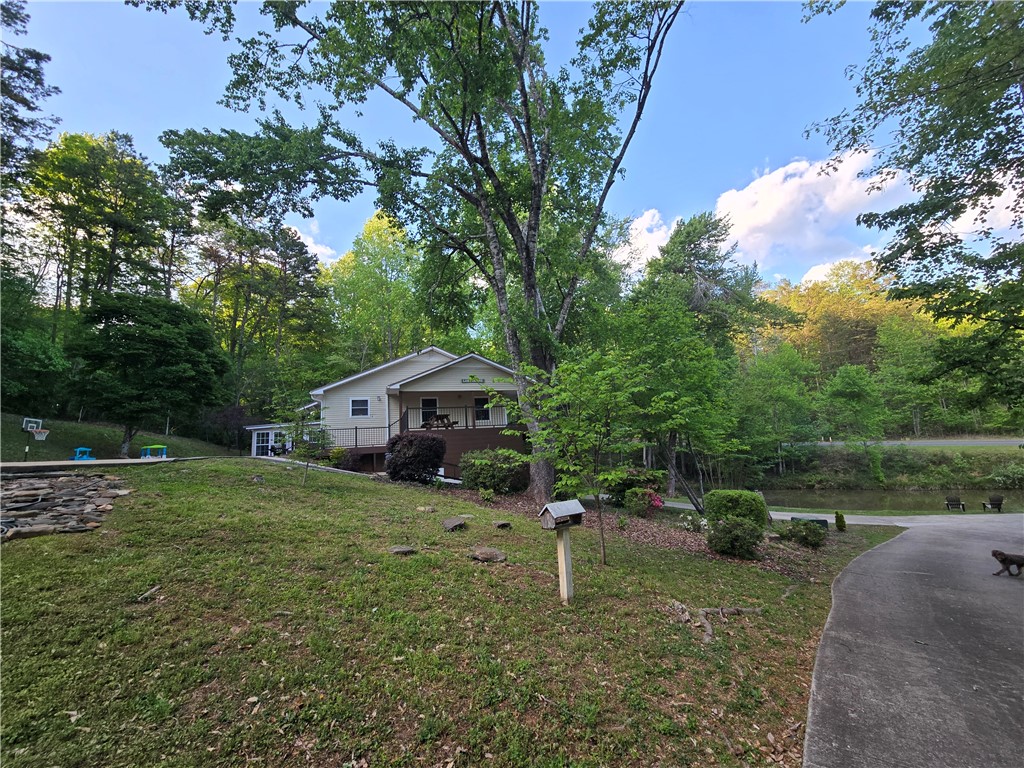 130 Greenbrier Road Salem, SC 29676 - Photo 45 of 48 This charming home features a lovely exterior, surrounded by lush greenery and a tranquil pond.