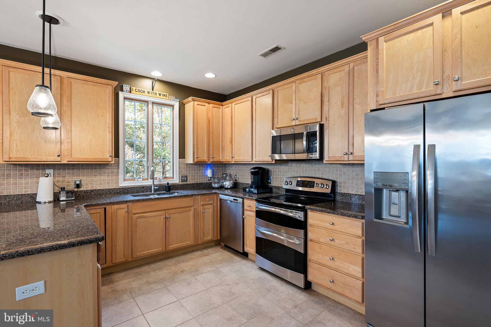 38744 Skipjack Village Road, Unit 14 Bethany Beach, DE 19930 - Photo 12 of 70 a kitchen with granite countertop a sink stainless steel appliances and cabinets