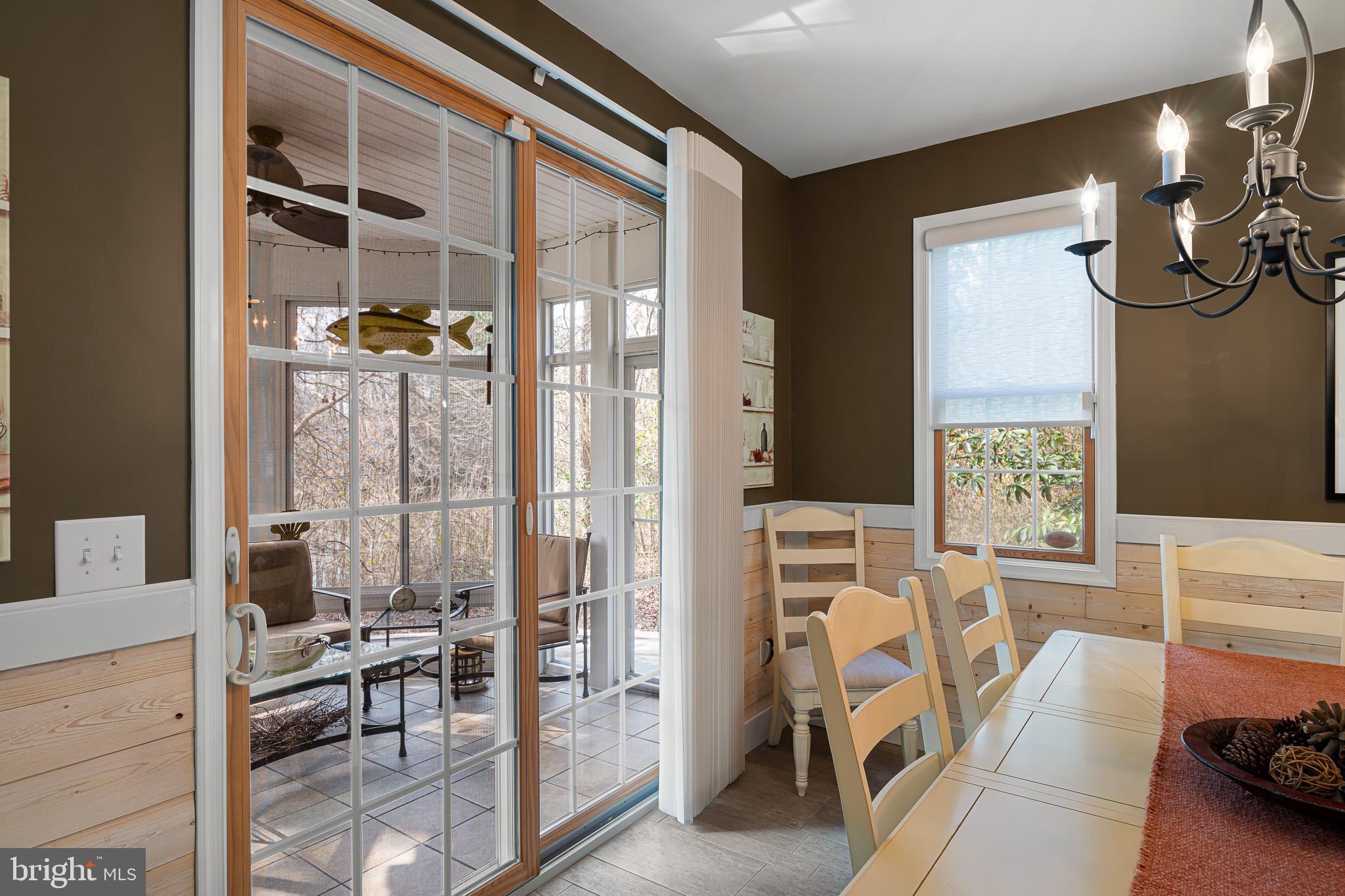 38744 Skipjack Village Road, Unit 14 Bethany Beach, DE 19930 - Photo 14 of 70 Sliding doors to the enclosed 3-season room