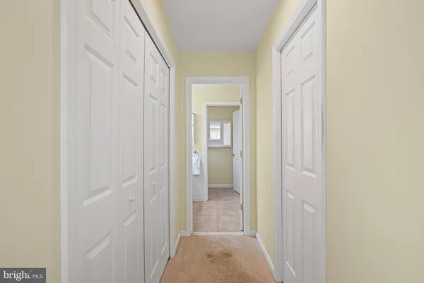 a bedroom with a bed a chandelier and a dresser