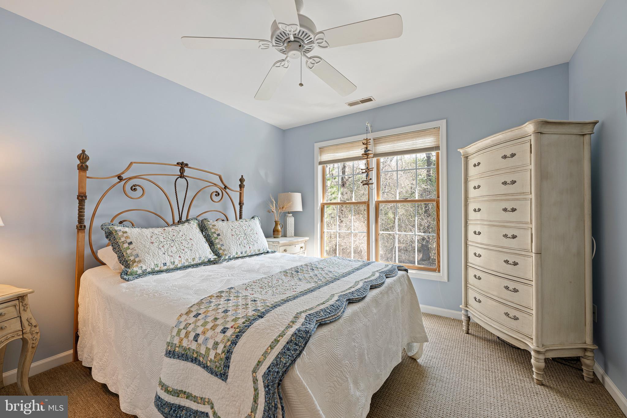 38744 Skipjack Village Road, Unit 14 Bethany Beach, DE 19930 - Photo 35 of 70 a bedroom with a bed a chandelier and a dresser