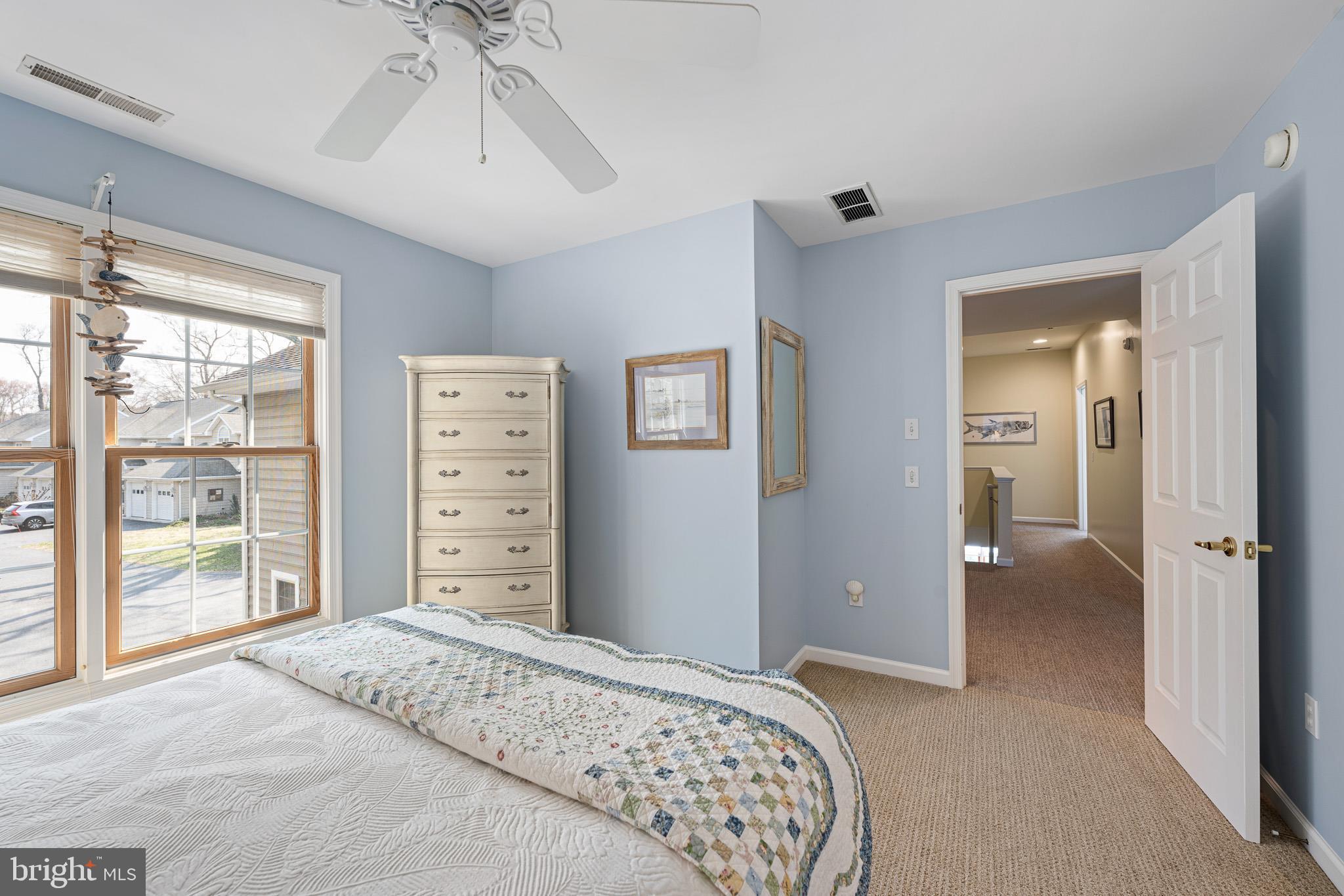 38744 Skipjack Village Road, Unit 14 Bethany Beach, DE 19930 - Photo 36 of 70 a bedroom with a bed and a chandelier