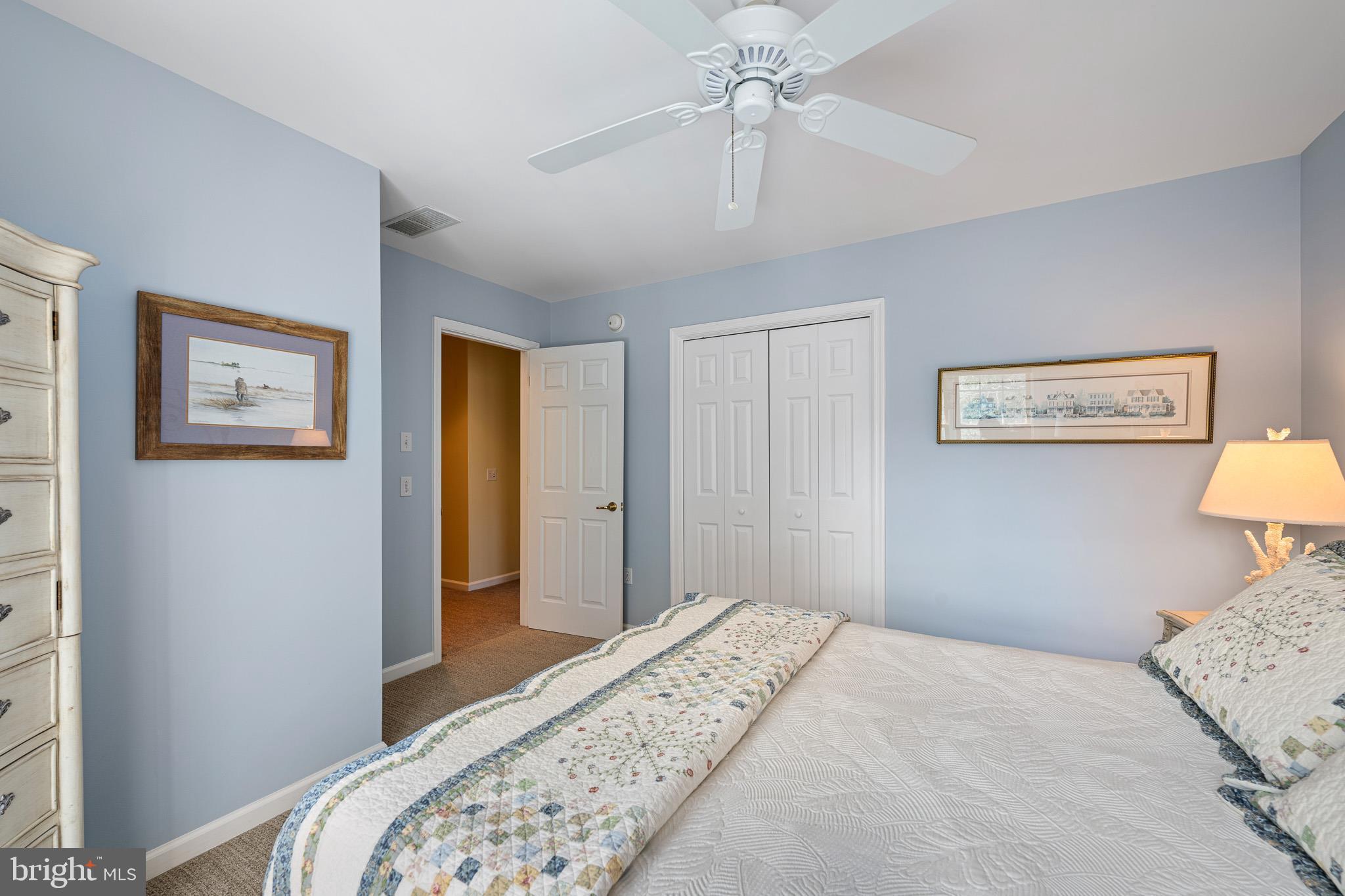 38744 Skipjack Village Road, Unit 14 Bethany Beach, DE 19930 - Photo 37 of 70 a bedroom with bed and a chandelier