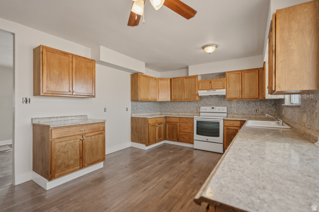 337 North Main Street Central Valley, UT 84754 - Photo 17 of 40 Kitchen featuring a ceiling fan, light countertops, white electric range oven, tasteful backsplash, and dark wood-style floors