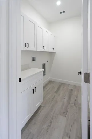 an empty room with stairs and wooden floor