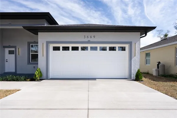 a front view of a house with garage