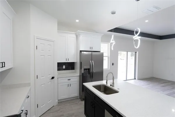 a kitchen with stainless steel appliances granite countertop a refrigerator and a sink