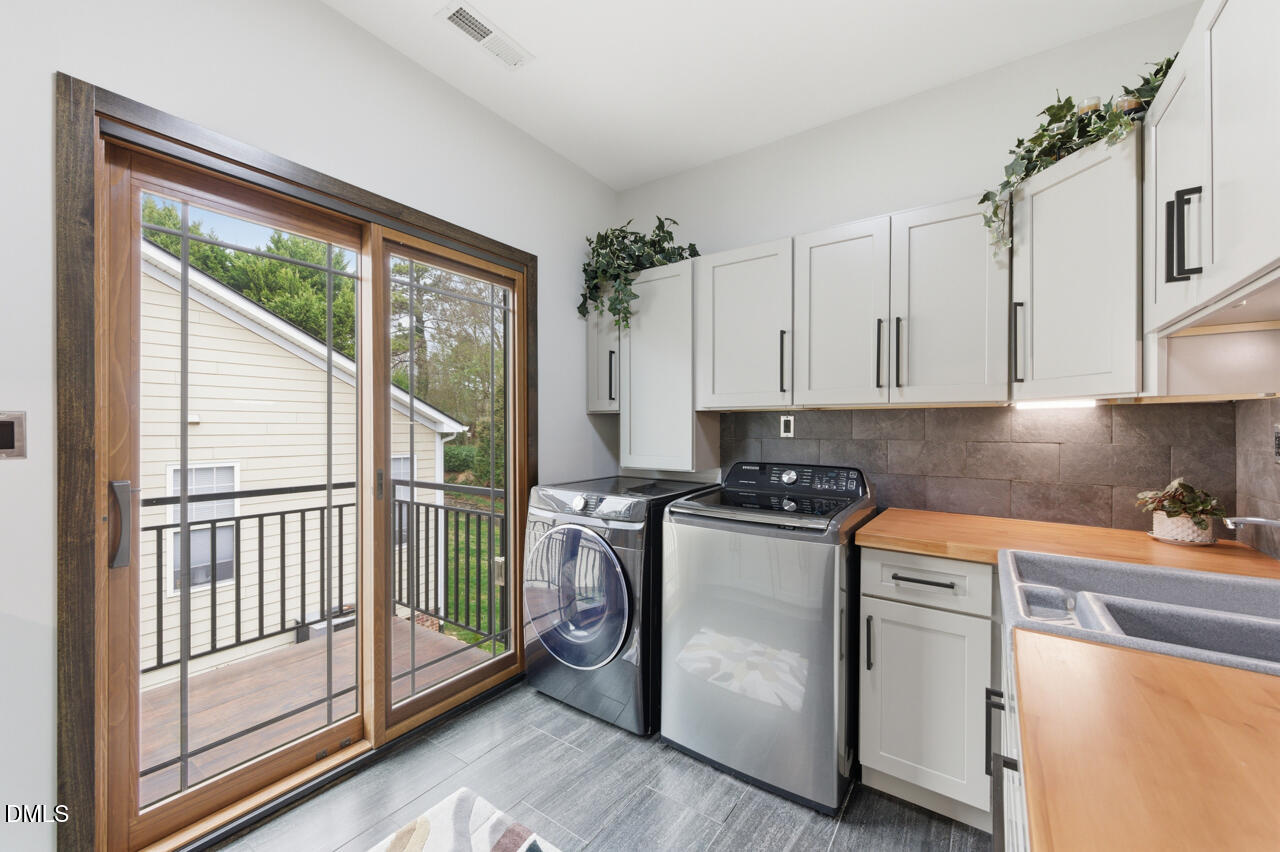 3315 Denada Path Durham, NC 27707 - Photo 70 of 74 a kitchen with stainless steel appliances granite countertop a stove a refrigerator and white cabinets