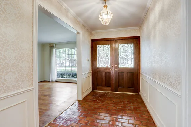 a view of hallway with a front door and wooden floor