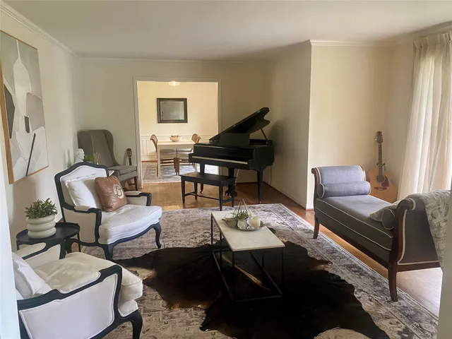 a living room with furniture rug and a window