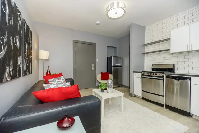 a living room with furniture kitchen and a window