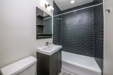 a bathroom with a sink mirror toilet and bathtub