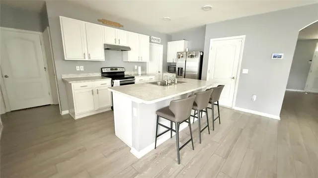 a bathroom with a sink a toilet a mirror and shower