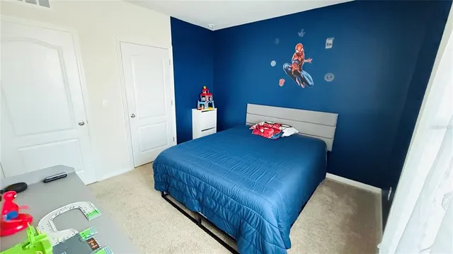 a bedroom with a bed and a table