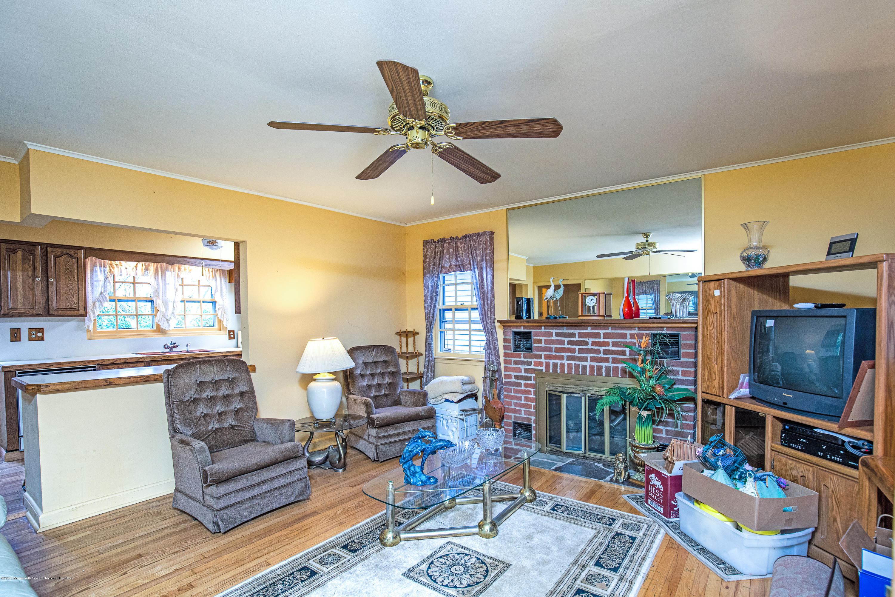 558 Carroll Fox Road Brick, NJ 08724 - Photo 6 of 39 a living room with furniture a flat screen tv and a floor to ceiling window