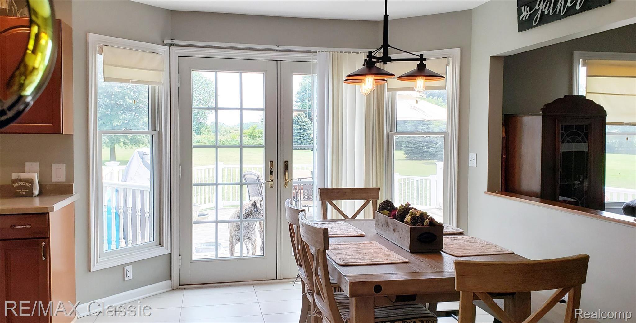8070 Oak Grove Road Howell, MI 48855 - Photo 12 of 34 Dining area with large window & doorwall to deck.