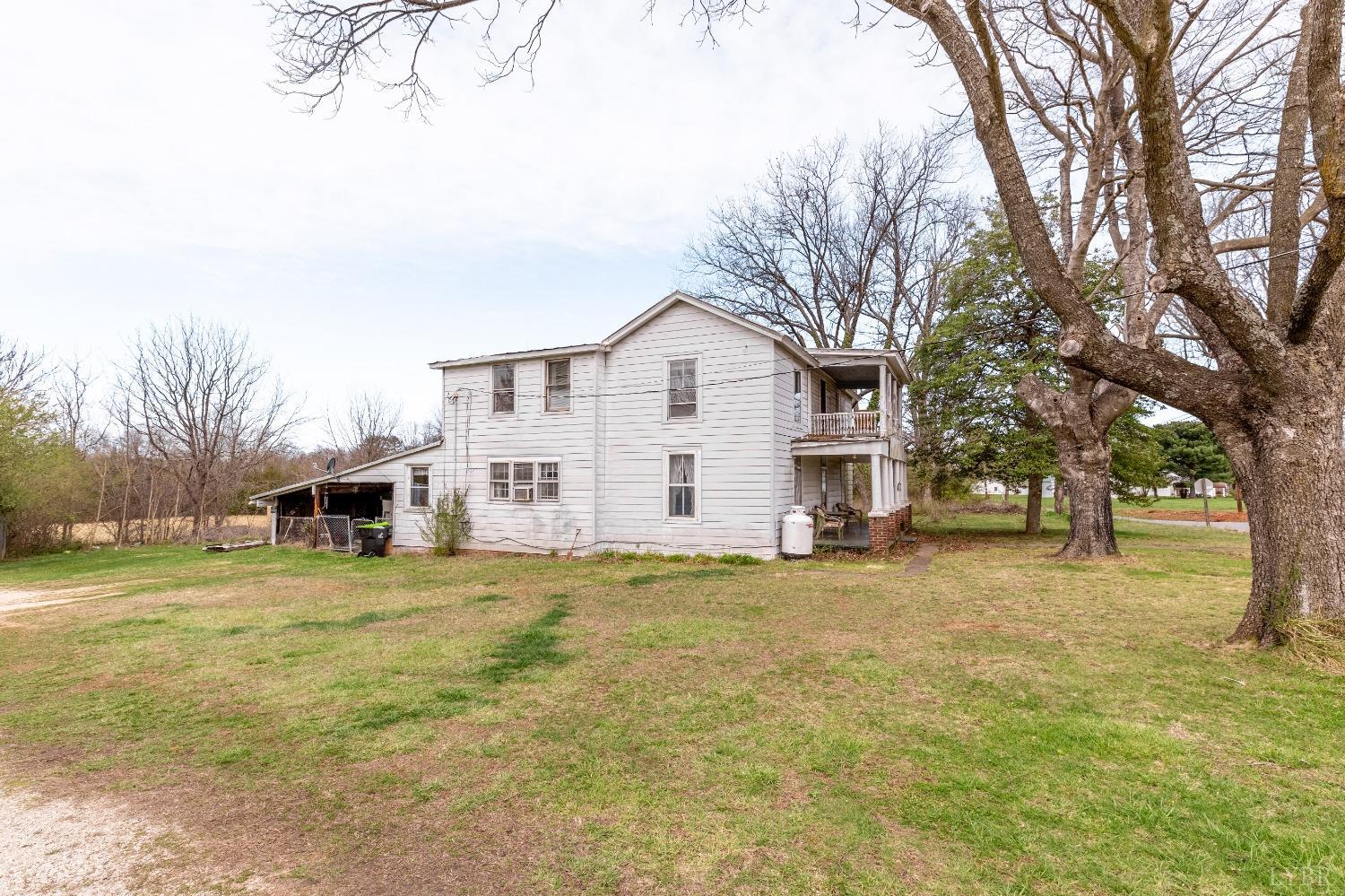 1795 Redfields Road Appomattox, VA 24522 - Photo 20 of 35 a view of a house with a big yard and large trees