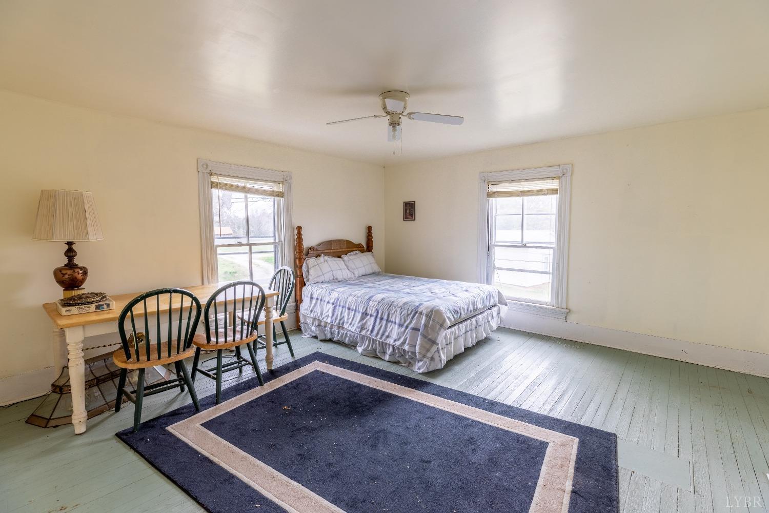 1795 Redfields Road Appomattox, VA 24522 - Photo 10 of 35 a bedroom with a bed a table and windows