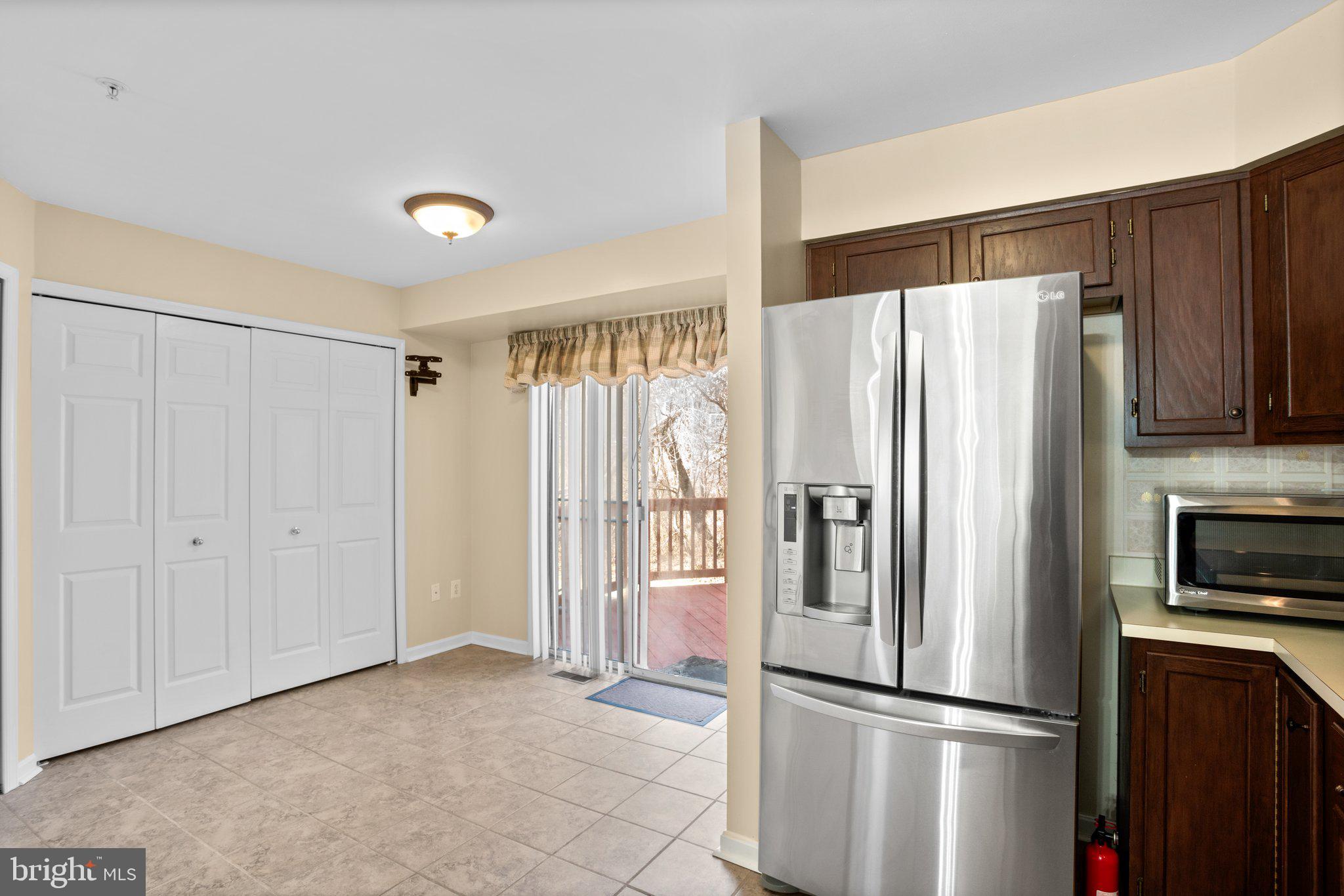 6342 Arbor Way Elkridge, MD 21075 - Photo 16 of 30 a metallic refrigerator freezer sitting in a kitchen