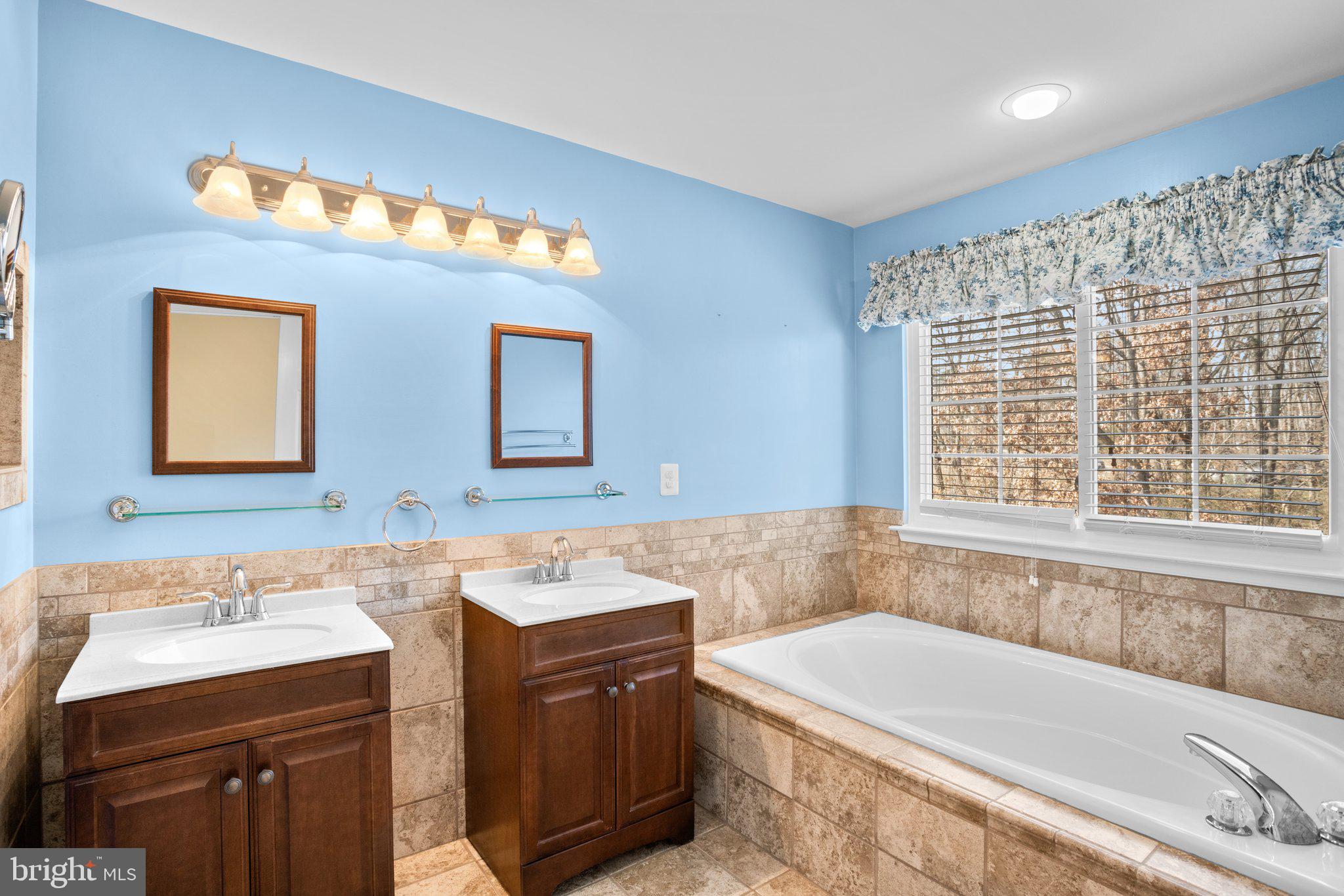 6342 Arbor Way Elkridge, MD 21075 - Photo 21 of 30 a bathroom with a tub sink and mirror