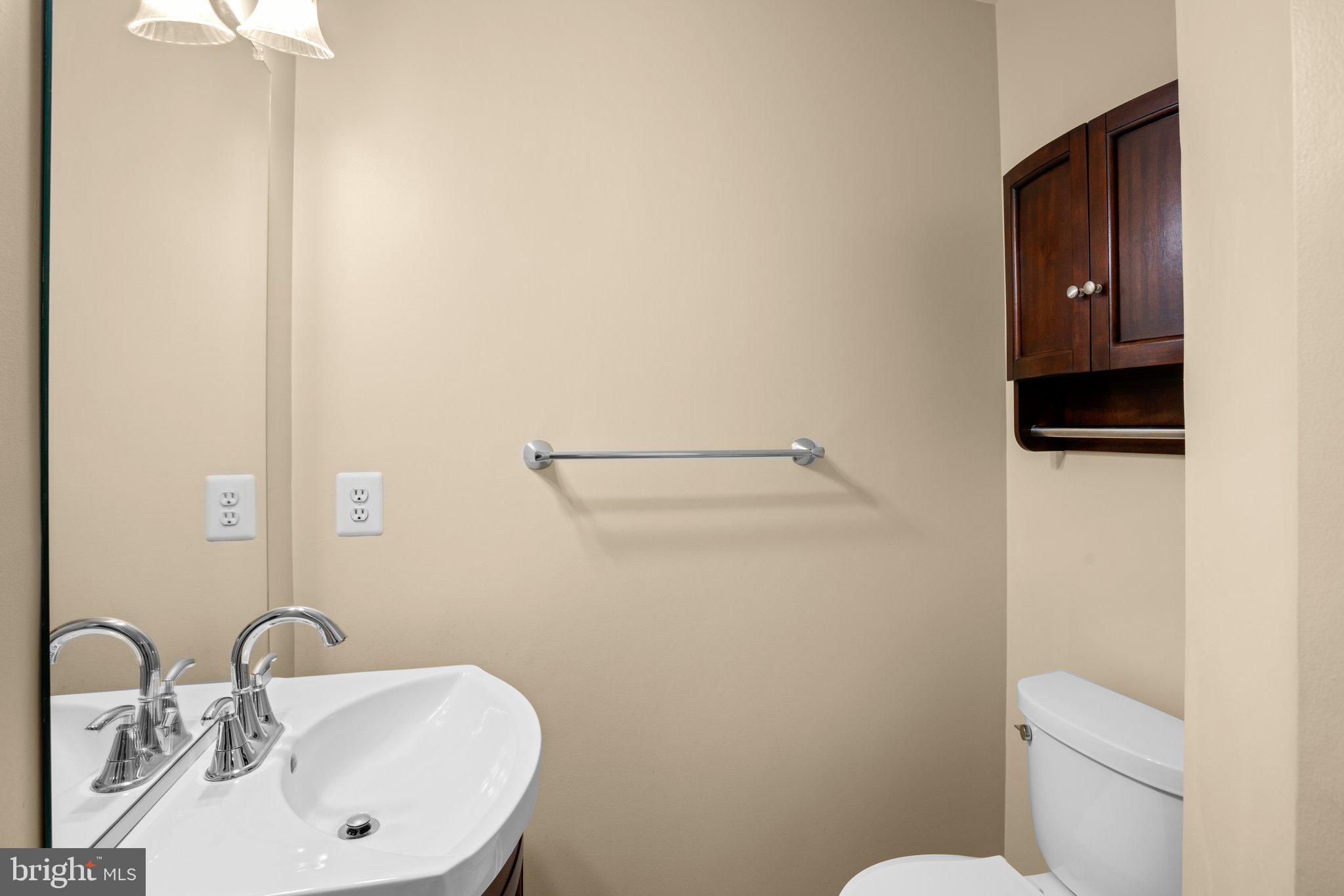 6342 Arbor Way Elkridge, MD 21075 - Photo 26 of 30 a bathroom with a sink a toilet and mirror